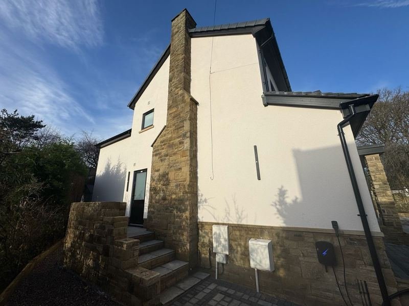 Side of the house in Adel, Leeds after silicone render, with cladding to the front