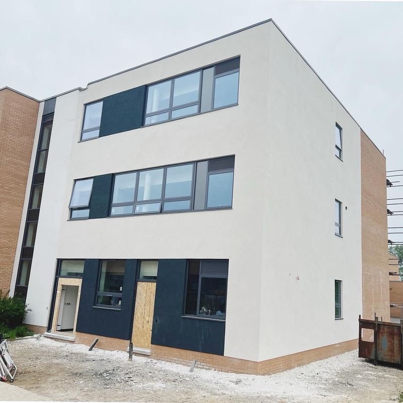 Front of the school in Bradford after monocouche render with silicone panels