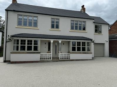View of the detached house in Adel, Leeds after through-coloured render